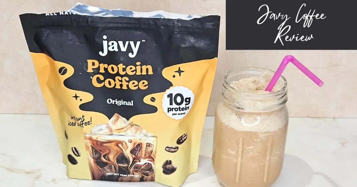 a bag of javvy coffee protein powder next to a glass mason jar with a purple straw sticking out of jar