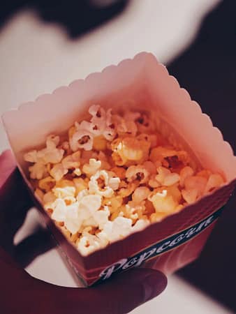 2 someone holding a popcorn box