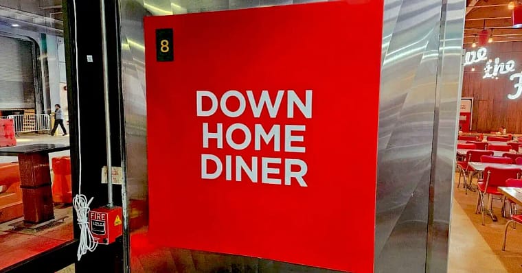 4-4 Down home diner sign in red with white lettering plastered on the wall