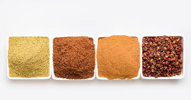 1 seasonings for food in white bowls forming a horizontal line