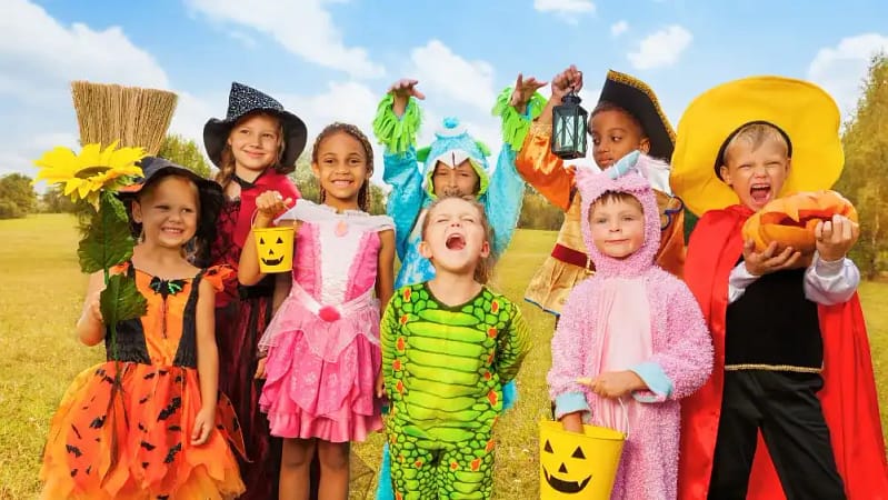 A bunch of kids showcasing fun costume ideas that include dinosaurs, unicorn, pirate and more.
