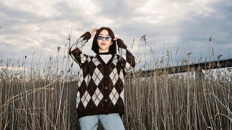asian woman with dark hair enjoying her fall weekend trip wearing fall clothes