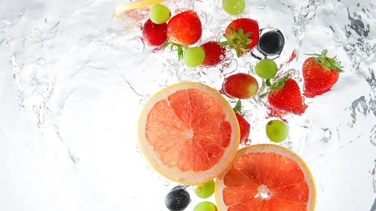 fruit water infusion showing grapefruit, grapes, and berries for simple hydration hacks